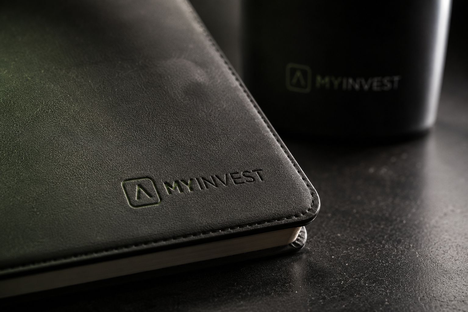 Debossed logo on a leather notebook